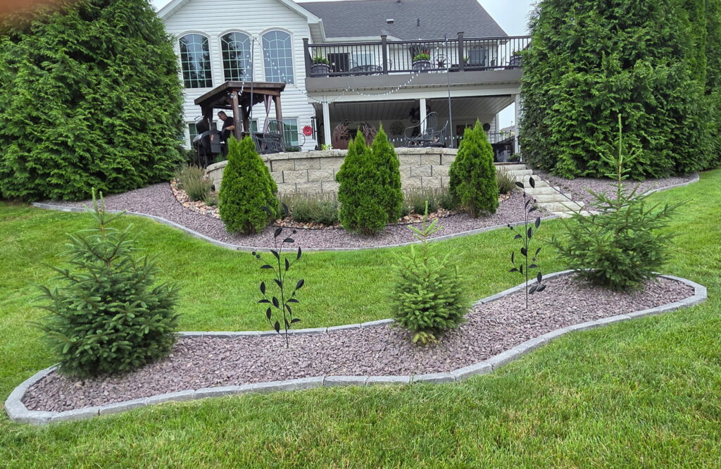 rock edgers and wall with bushes installed